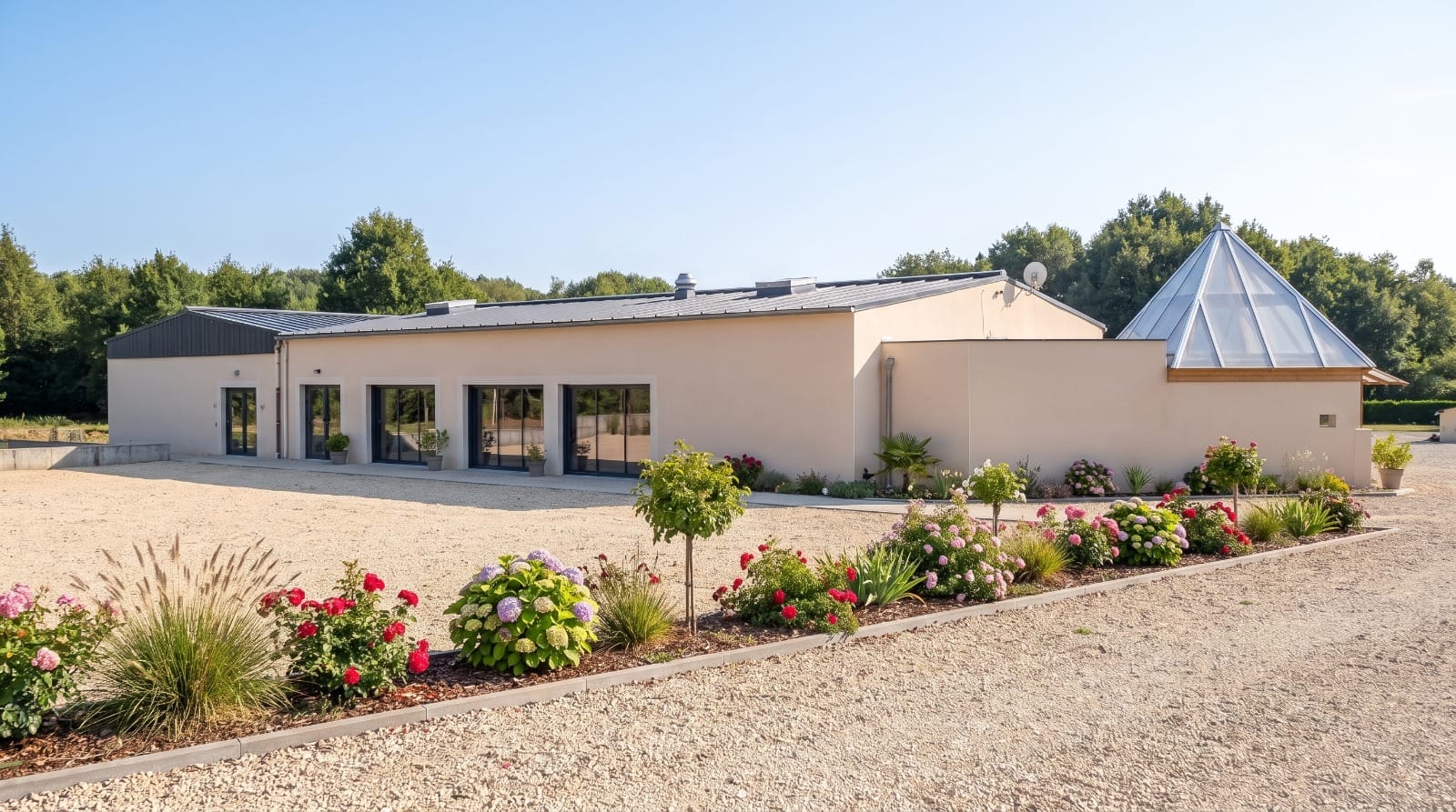 La Salle Robinson vue depuis l’allée, avec sa verrière pyramidale et ses massifs fleuris